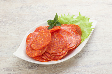 Sliced pepperoni sausage in the bowl