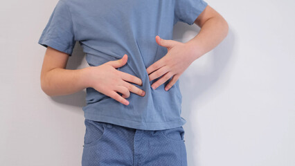little boy experiences abdominal pain. Baby's medication and health concept. Stomach ache....