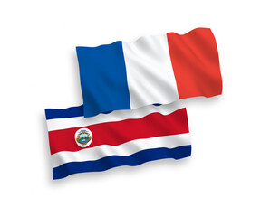 National vector fabric wave flags of France and Republic of Costa Rica isolated on white background. 1 to 2 proportion.