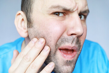 Obraz premium A man shaves in front a mirror. Shaving foam. Disposable razor.