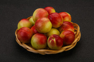 Sweet small nectarines in the basket