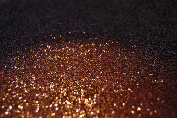 Golden focused sparkle glitter background close up