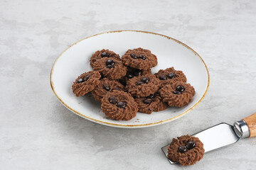 Chocolate chips cookies, served on chopping board, close up. Popular to celebrate Eid al Fitr. Selective focus.
