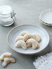 Kue Putri Salju or Snow White Cookies with crescent shaped. Made from flour, sugar and butter coated with powdered sugar. Popular to celebrate Eid al Fitr. Selective focus image.
