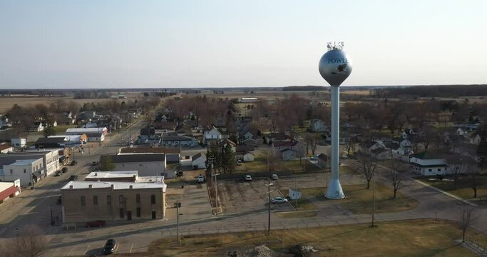Downtown Fowler Michigan drone video flying sideways.