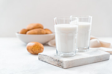 Vegetarian potato milk in two glasses on a white background.