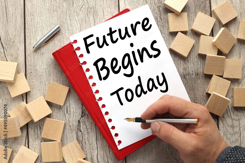 Poster text on a sheet of paper on a notepad. the text is written by a man future begins today