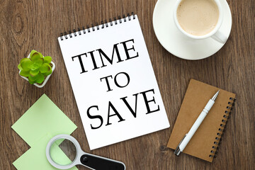 time to save. notepad on a wooden background with text