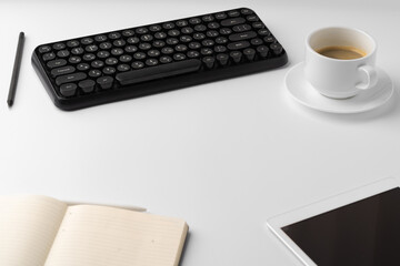 Office desk with laptop, blank notebook and coffee cup