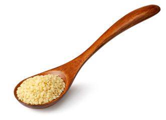 Raw hemp seeds in the wooden spoon, isolated on the white background.