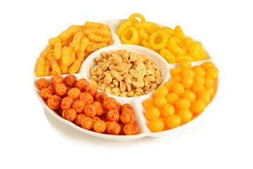 Mix of snacks on a white plate isolated on white.