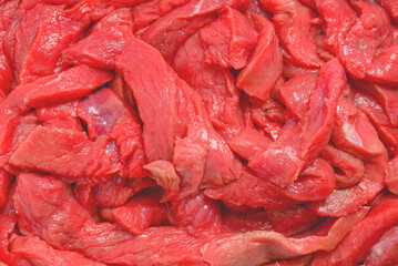 Raw veal pieces background.  Beef stroganoff.
