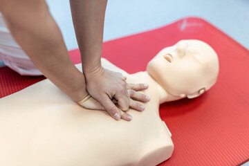 CPR class with instructors talking and demonstrating firt aid, compressions ans reanimation procedure. Cpr dummy