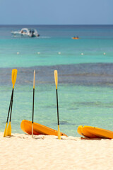  Orange boats with oars on the sandy shore. Beautiful seascape on the Caribbean Sea in the Dominican Republic