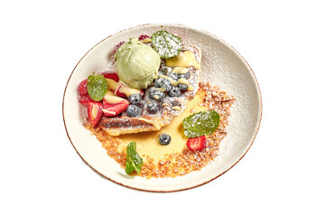 Belgian waffles with ice cream and fruit in a bowl on a white background