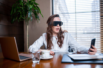 Business lady in virtual reality glasses at work. Woman leader or student has fun and plays virtual games.