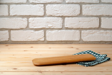 Cutting board with cotton napkin on wooden table