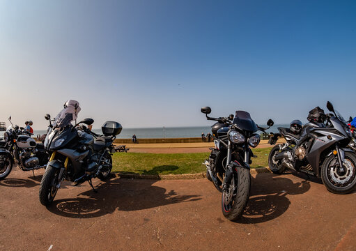Hunstanton, Norfolk, UK - March 2022.. Ultra wide angle fisheye view of motorcycles parked up on Hunstanton seafront, North Norfolk coast