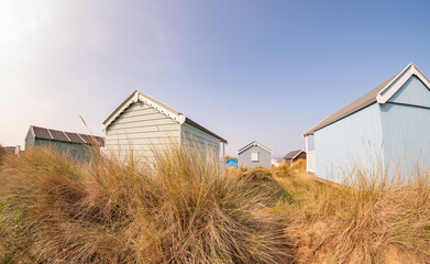 Ultra wide angle fisheye shot of traditional wooden beach huts on Hunstanton beach on the North Norfolk coast