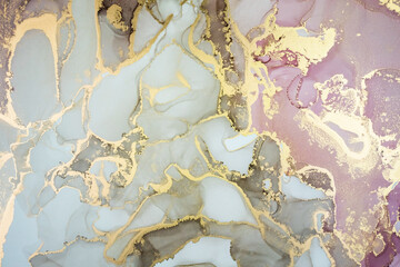 Luxury abstract painting in fluid art technique.Transparent layers of pastel pink, brown and gold paints create marbled texture of stripes, swirls and veins with glowing gold and glitter.