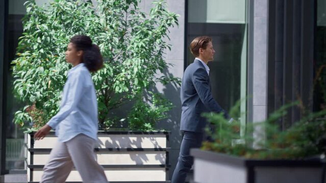 Bank manager going for walk on lunch break in modern downtown city street.