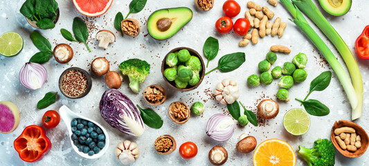 Vegan diet with a high content of dietary fiber and strengthens the immune system: fresh vegetables, fruits, nuts, mushrooms and berries. On a gray stone background. Top view.