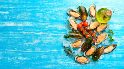 Raw mussels with spices on ice. On a blue background. Free space for text.