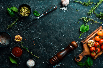 Black stone cooking background. Fresh vegetables and spices on a stone table. Top view.