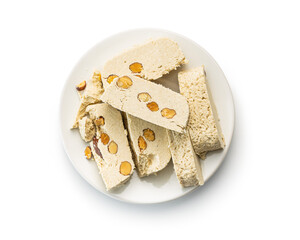 Sweet tahini halva with almonds. Turkish dessert isolated on white background.