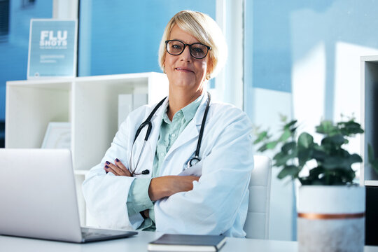 As A Caregiver, You See Selfless Acts Everyday. Shot Of A Female Doctor Sitting In Her Office.