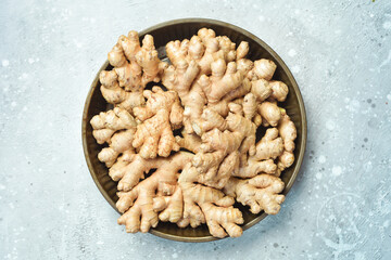 Ginger root in a box. Foods containing vitamin C. Free space for text on a stone background.