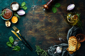 Cooking background. Vegetables, spices and kitchen utensils on a stone background. Top view.