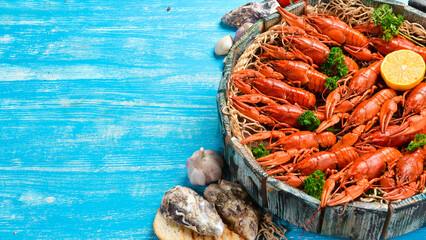 Big set of red crayfish in a wooden box. Seafood. Top view. Flat lay.