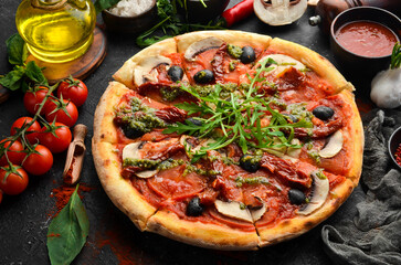 Homemade pizza with sun-dried tomatoes, mushrooms and olives. Italian cuisine. Food delivery.