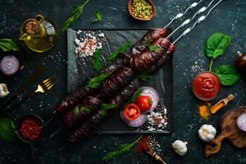 Juicy delicious baked pork sausages. Skewers. Barbecue menu. Top view. Free copy space.