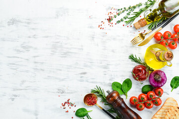 White wooden background of cooking. Spices and vegetables. Top view. Free space for your text.