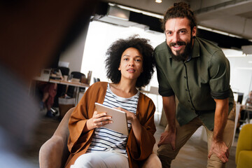 Portrait of creative business people team working together and smiling in office.