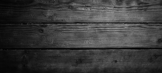 Black charred wooden background. Wood texture. Top view. Free space for your text.