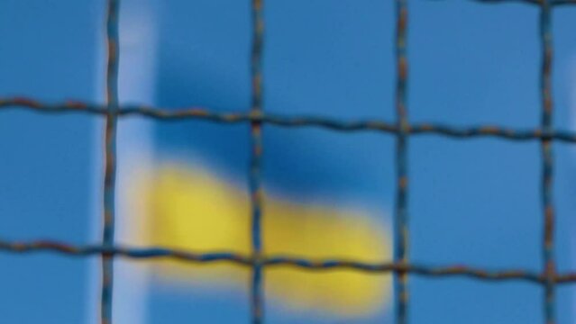 Waving flag of Ukraine on the blue sky background