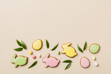 holiday preparation Multi colors Easter eggs with cookies on colored background . Pastel color...