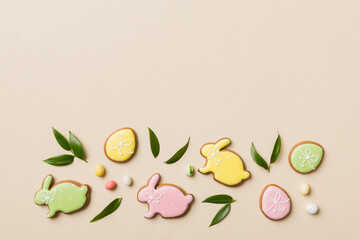 holiday preparation Multi colors Easter eggs with cookies on colored background . Pastel color Easter eggs. holiday concept with copy space