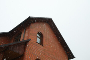 Big brick house on a beautiful snowy day