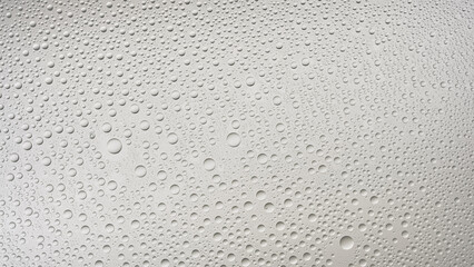 Glass surface covered with water drops against grey background | Overlay foreground or background for skin care moisturizing products