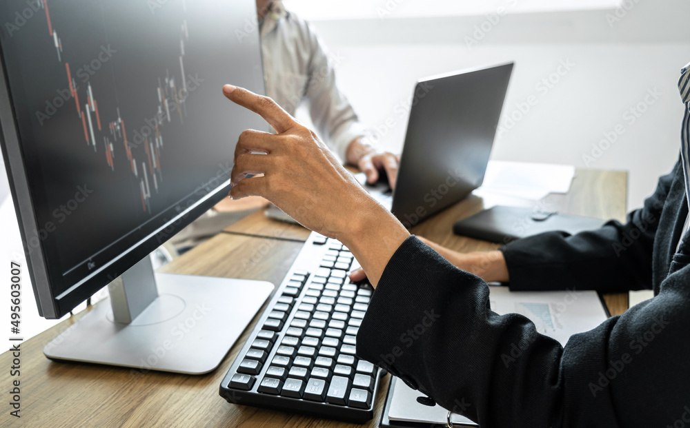 Poster business team two colleagues working with computer, discussing and analysis graph stock market tradi
