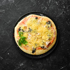 Homemade pizza with mushrooms, cheese and basil. Top view. Rustic style.