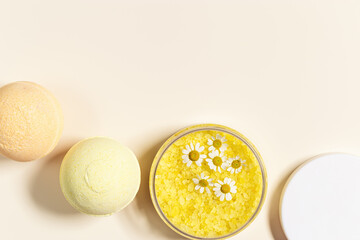 Bath bomb, bath salt sea with herbal extract of chamomile, sea salt crystals in jar, natural chamomile flowers. Home care concept, relax and rest, bath procedure, body care cosmetic