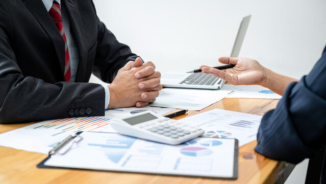 Business team is checking business document and brainstorming about new startup project while meeting together