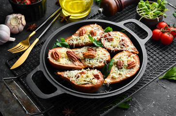 Baked pears with blue cheese and nuts. In a frying pan. Rustic style. Flat Lay.