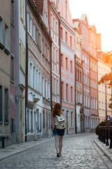 a girl walks through the streets of an old European city