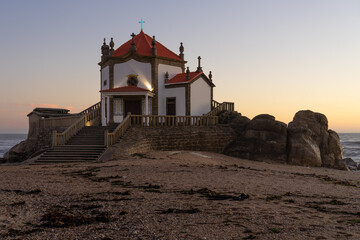 Capela do Senhor da Pedra or Lord of the rock chapel illuminated at night, Miramar, Portugal